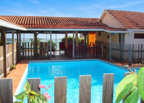a swimming pool in front of a house at Maison spacieuse avec piscine privée à Le François in Le François