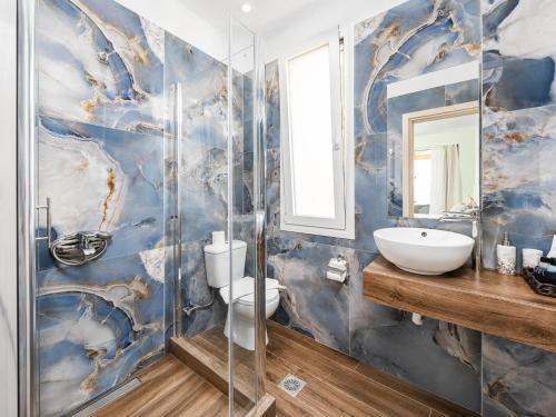 a bathroom with a sink and a toilet at Villa Alora in Barbati