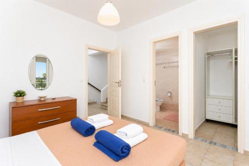 a bedroom with a large bed and a bathroom at Hermione Villa in Gennadi