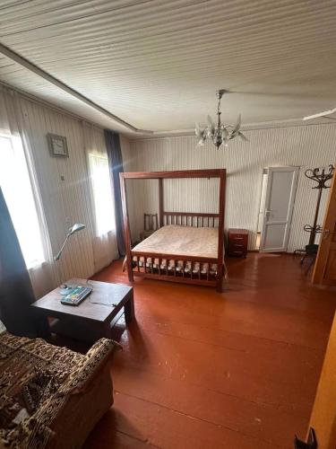 a living room with a bed and a couch at Guest House Babi in Letsperi