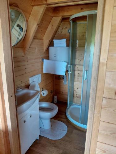 a small bathroom with a toilet and a shower at Glamping Čelig in Donja Višnjica