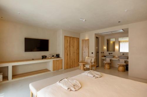 a bedroom with a bed and a bathroom with a sink at La Gaia - Adult Only in Alanya