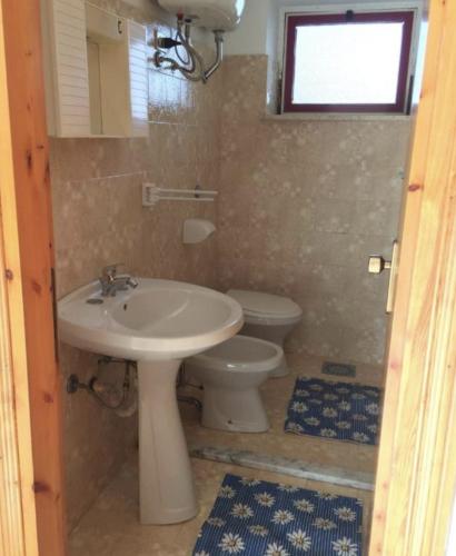a bathroom with a sink and a toilet at Campeggio 2 Mari in Ovile la Marinella