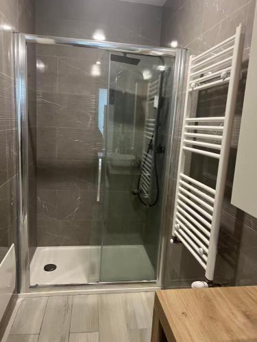 a shower with a glass door in a bathroom at Casaxxvaprile in Turin