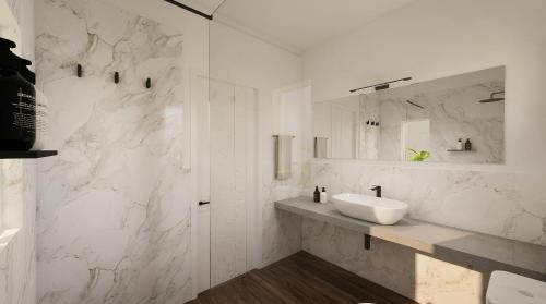a white bathroom with a sink and a mirror at Nala Inn in Fulidhoo