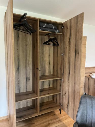 a closet with wooden walls and wooden shelves at Ferienwohnung Lisa in Grabenstätt