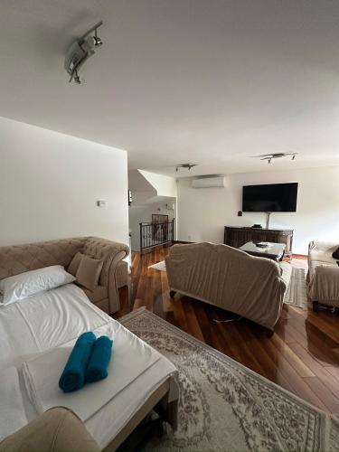 a living room with a couch and a tv at Prestige Old Town Villa in Sarajevo
