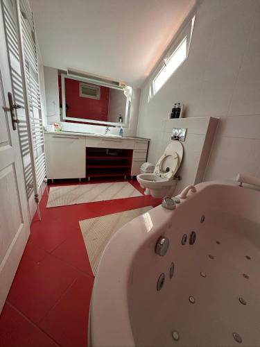 a bathroom with a tub and a toilet and a sink at Prestige Old Town Villa in Sarajevo