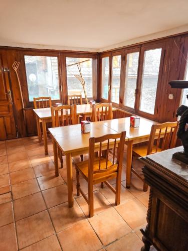a dining room with tables and chairs and windows at Spacious House in Canejan with Mountain View in Caneján