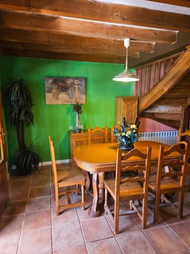 a dining room with a wooden table and chairs at Spacious House in Canejan with Mountain View in Caneján