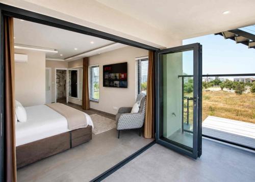 a bedroom with a bed and a sliding glass door at Grey Stones Villa by HolidayKeys in Kyrenia