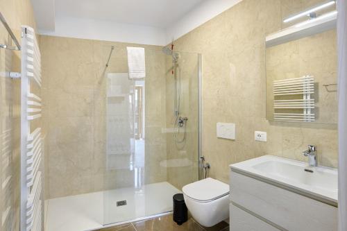 a bathroom with a shower and a toilet and a sink at Al Casel - Appartamento Collina in Torri del Benaco