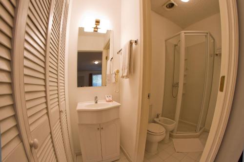 a bathroom with a sink and a toilet and a shower at Family Inn in San Rafael