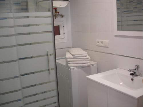 a bathroom with a sink and a toilet and towels at Primavera - Zand Properties in Benidorm