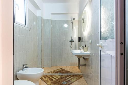 a bathroom with a toilet and a sink at Dhermi's Icon Big 1BR Apt 9 in Dhërmi