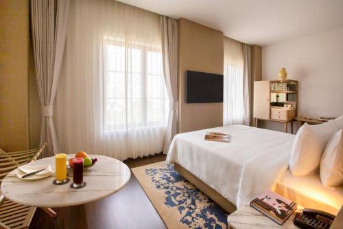 a hotel room with a bed and a table at DLF Club 4 in Gurgaon