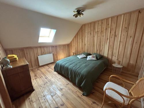 a bedroom with a bed and a ceiling fan at Golden Nest in Courteranges