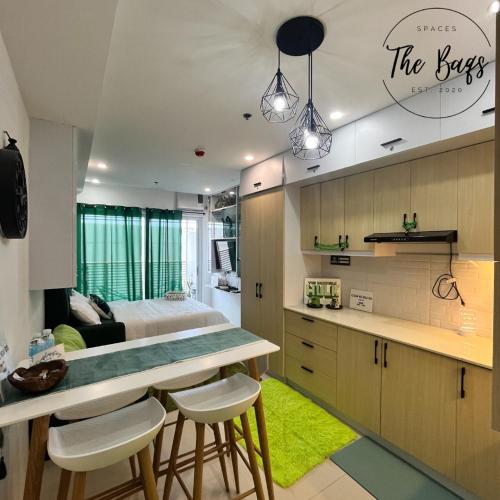 a kitchen and living room with a bed in the background at Marvel Fan Studio Condo with Pool CDO TheBaqs in Balulang