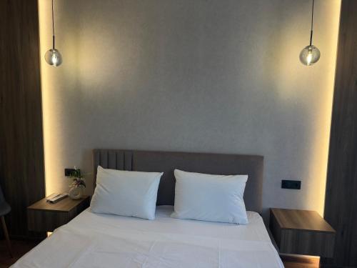 a bedroom with a bed with two white pillows at Family 30 in Lutsk