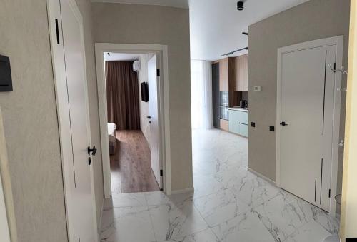 a room with a hallway with white marble floors at Family 30 in Lutsk