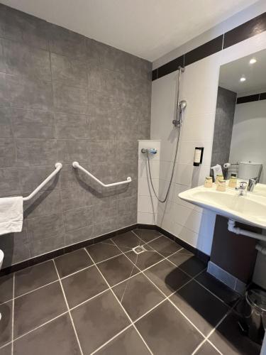 a bathroom with a shower and a sink at Hôtel Le Palladior Voiron in Voiron