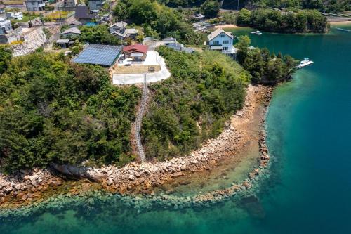 an aerial view of a house on an island in the water at ヴィラ倉橋 in Kure