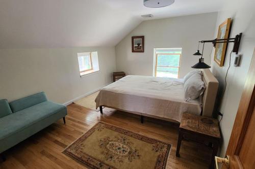 a bedroom with a bed and a couch at Shelburne Falls on Main in Shelburne