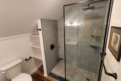 a bathroom with a toilet and a glass shower at Shelburne Falls on Main in Shelburne