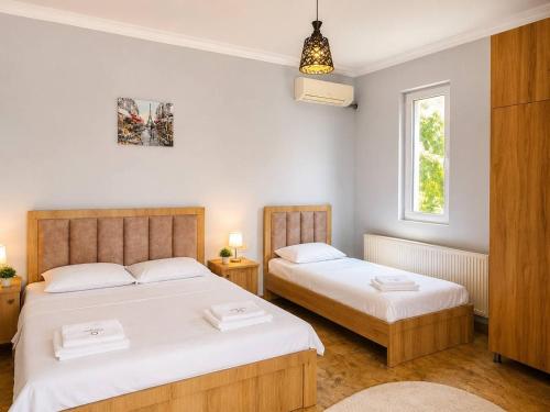 a bedroom with two beds and a window at IVERIA BEACH in Kobuleti