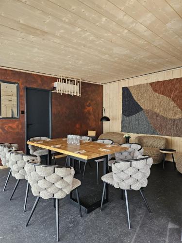 a conference room with a wooden table and chairs at Pépites Lodges et Spas - Prémilhat in Prémilhat