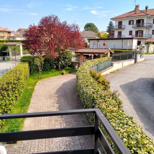 a brick walkway with a fence and a tree at Casa dei Nipotini con Posto Auto Riservato in Paganica