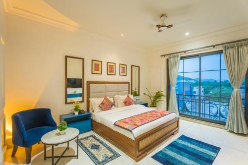 a bedroom with a bed and a large window at Tripli Hotels Blue Moon in Udaipur