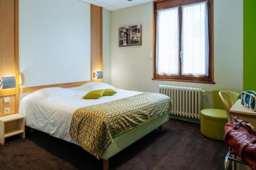 a bedroom with a bed and a window at Logis Hôtel Restaurant Bellevue Annecy in Annecy