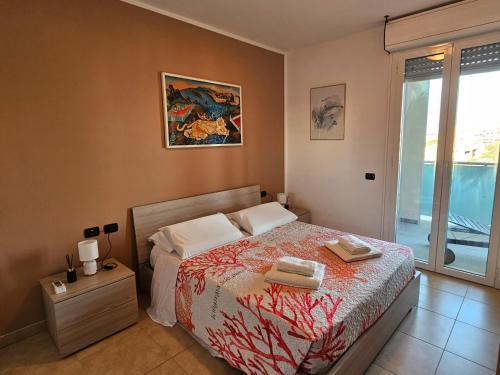 a bedroom with a bed with two towels on it at Holidaysshogun 2 in Lido di Ostia
