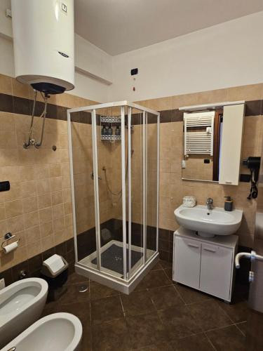 a bathroom with a shower and a toilet and a sink at Holidaysshogun 2 in Lido di Ostia