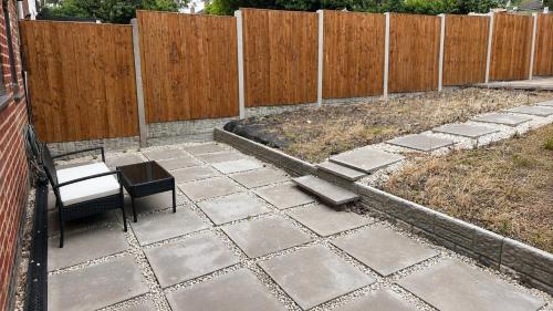 a patio with a table and chairs and a fence at Ready Stay Work Lodge in Birmingham