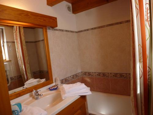 a bathroom with a sink and a mirror and a tub at Mountain Lodge in Alps-chez Philippe, Panoramic-Village, Renting, view over Glaciers in La Grave