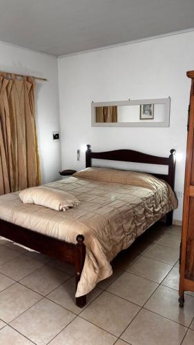 a bedroom with a large bed in a room at Espacio Canela monoambiente in Ramallo