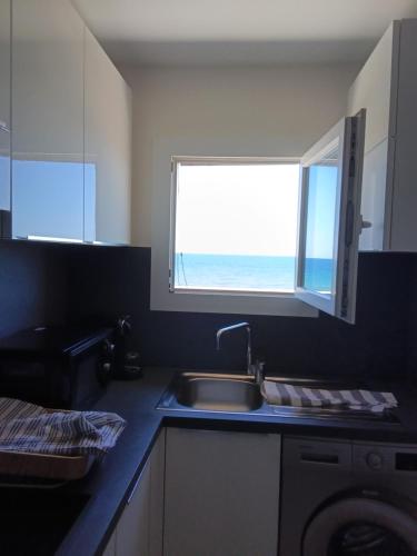 a kitchen with a sink and a window at Maria beach in San-Nicolao