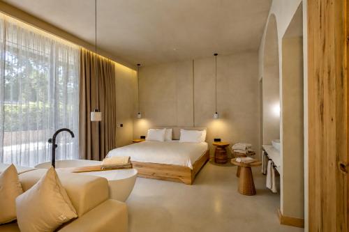 a hotel room with a bed and a bath tub at La Gaia - Adult Only in Alanya