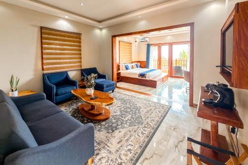 a living room with a blue couch and a table at Mozza Beach Resort in York