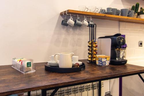 a counter with cups and a coffee maker on it at Charming Studio with Pool Retreat in Arroyomolinos