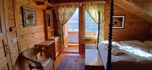 a bedroom with a bed in a log cabin at Family Home in Fáskrúðsfjörður