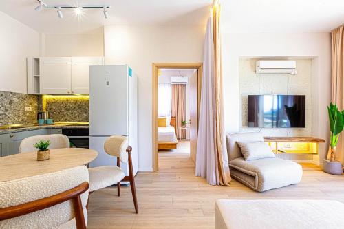 a kitchen and a living room with a table at Dhermi's Icon Big 1BR Ap 15 in Dhërmi
