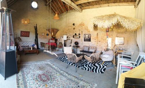 a living room with a zebra patterned rug at Le Clos St Justin Votre étape sur la route des vacances à 10 mn de Center Parc et Chambord in Ligny-le-Ribault