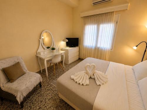 a bedroom with a bed and a chair and a mirror at Central Mytilene City-View Apartment for 7 in Mytilene