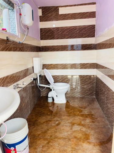 a bathroom with a toilet and a sink at Skyblue cafe in Tosh