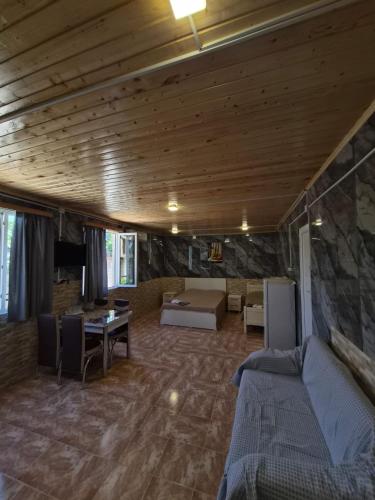 a living room with a couch and a table at Guest House in Ureki in Ureki
