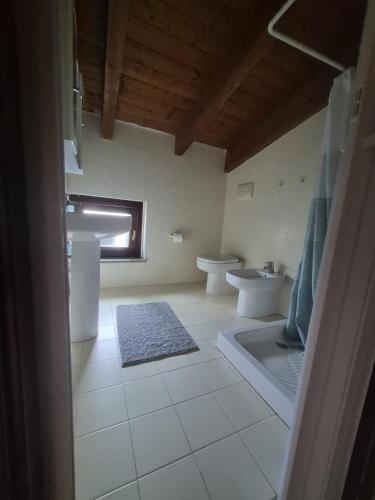 a bathroom with a sink and a toilet and a tub at VILLA ANNAMARIA in Montesilvano