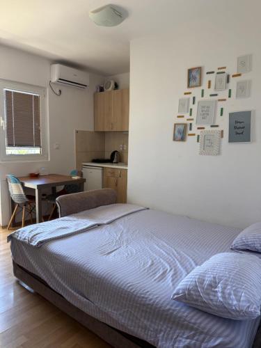 a bedroom with a bed and a kitchen with a table at Power view in Bečići
